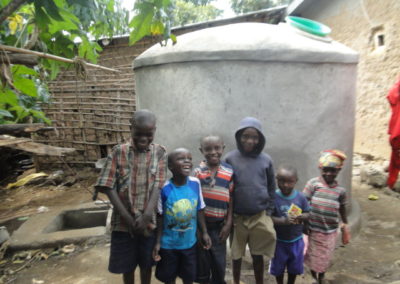 Kids pose in front of water tank