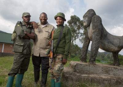 Park rangers Safari Jules, left, and Naomie Divine Kashalulo, right, with Dr. Augustin Basabose