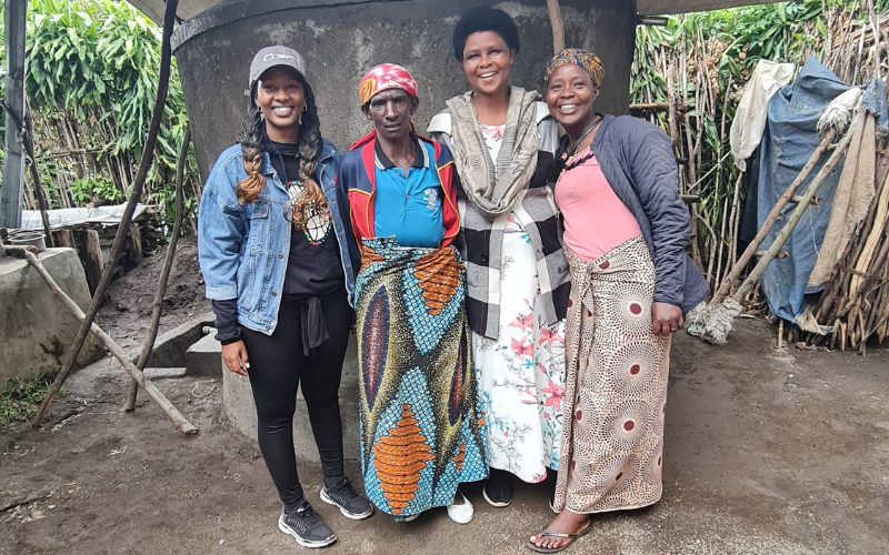 Women with a household rainwater tank in Rwanda