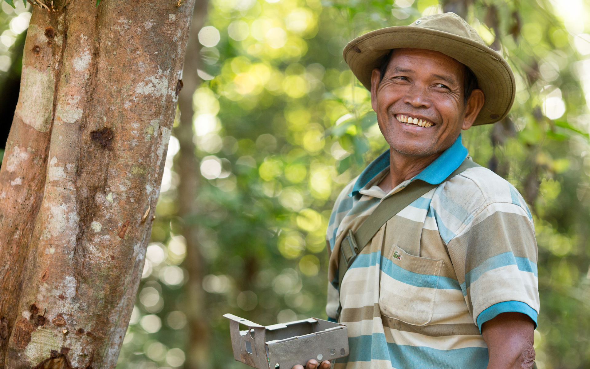 Srey Ben examines a surveillance camera trap at a mineral lick in Prey Lang. 