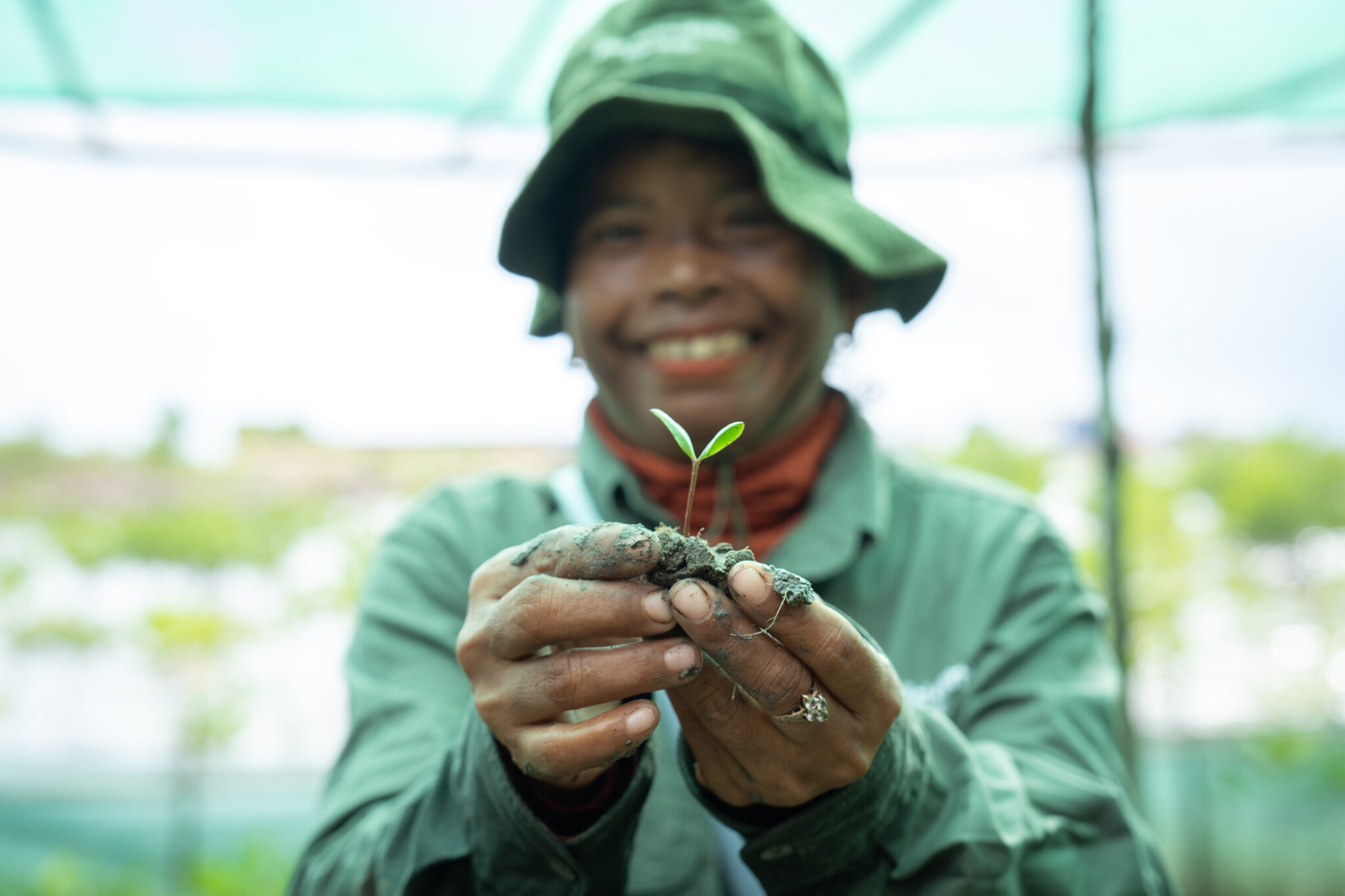 24Aug2025_Kampot Cam1 by KimlongMeng-43 A smiling woman holds a mangrove seedling.